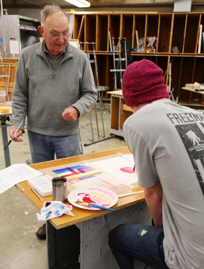 Volunteer teacher Ernie Weiss commends treasurer Chad MacPhearson’s attention to detail at the Art Club’s Watercolor Workshop on Thursday in the Fine Arts Building. 