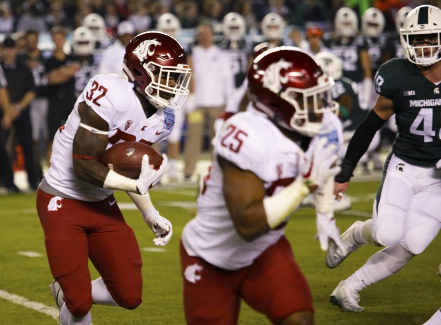 Redshirt sophomore running back James Williams runs the ball with redshirt senior running back Jamal Morrow lead blocking during the Holiday Bowl.
