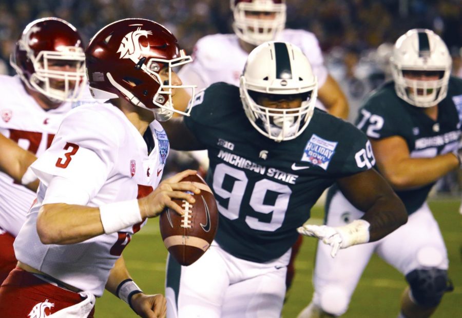 Then-redshirt sophomore quarterback Tyler Hilinski runs the ball down the field to get a first down against Michigan State during the Holiday Bowl.