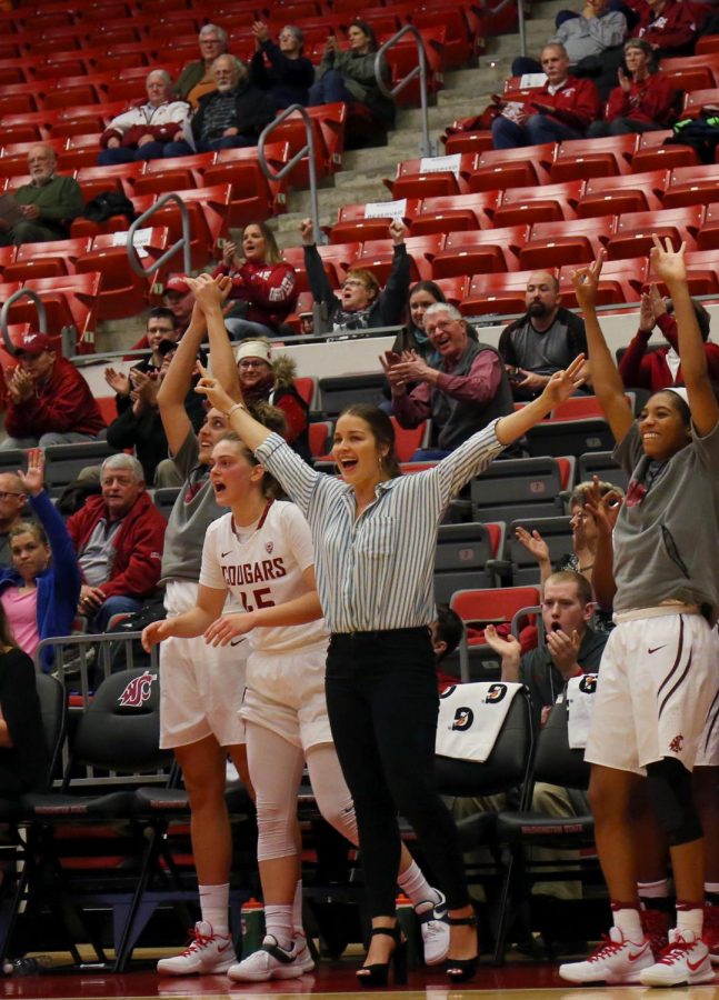 Fans, coaches and teammates cheer at womens basketball vs. St. Louis on Dec. 4.