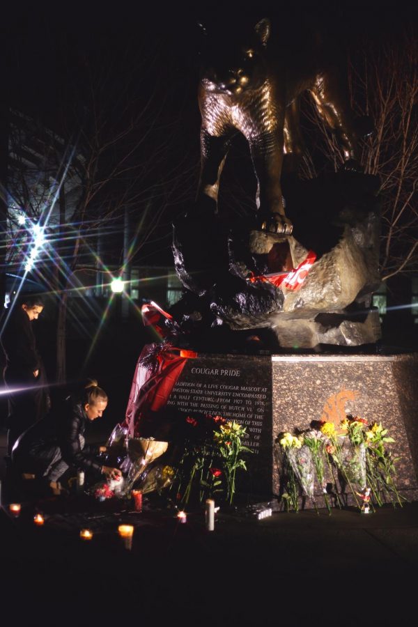 Members+of+the+WSU+community+bring+flowers+and+candles+to+set+in+front+of+Butchs+statue+outside+of+Martin+Stadium+to+show+their+love+for+Tyler+Hilinski+late+Tuesday.