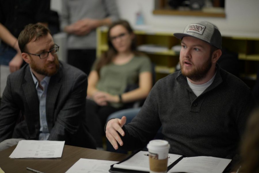 Advertising Manager Jacob Wagoner, right, explains how declining advertising sales contributed to The Daily Evergreen deficit at the Jan. 10 Student Media Board meeting. 