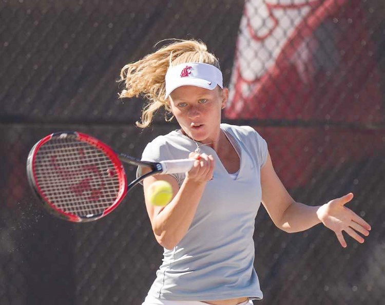 Junior Aneta Miksovska eyes her shot and prepares to hit a tennis ball in a previous match.