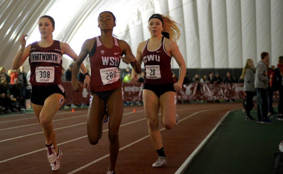 Redshirt junior hurdler Adreonia Bradley, middle, keeps a tight lead on her opponents during her 400 meter dash heat at the WSU Indoor Open at the Indoor Practice Facility.