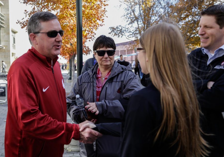Kirk Schulz shakes hands with then senior kinesiology major Ariel Bowman while participating in a student-organized walk 
for Exercise is Medicine On Campus on Oct. 23. The walk promotes physical health and awareness for the WSU community.