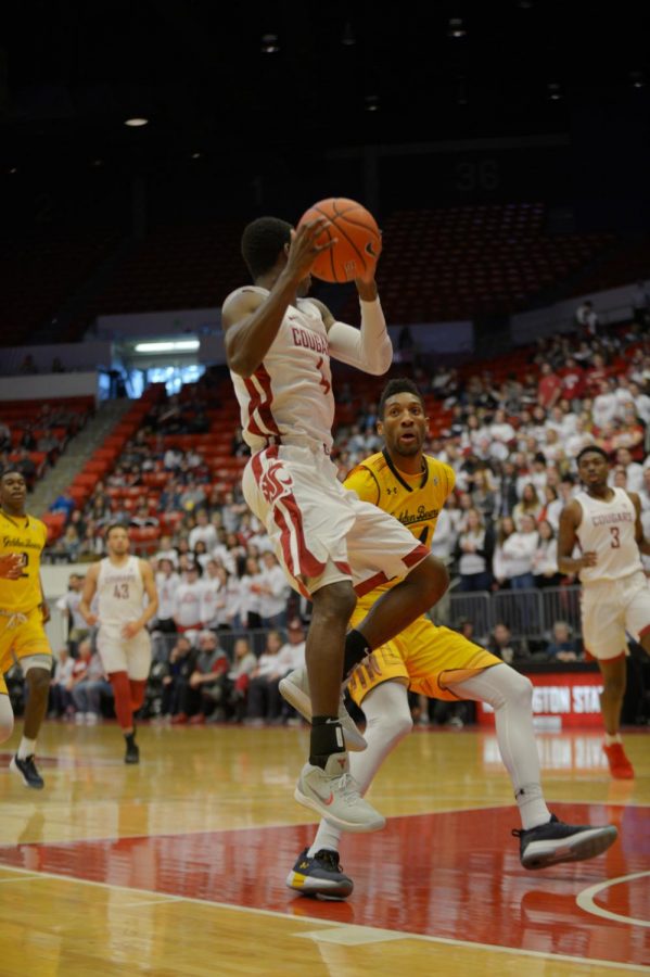 Junior Guard Vionte Daniels holds the ball as he lands from a jump during the game against the California Golden Bears Saturday afternoon at Beasley Coliseum.