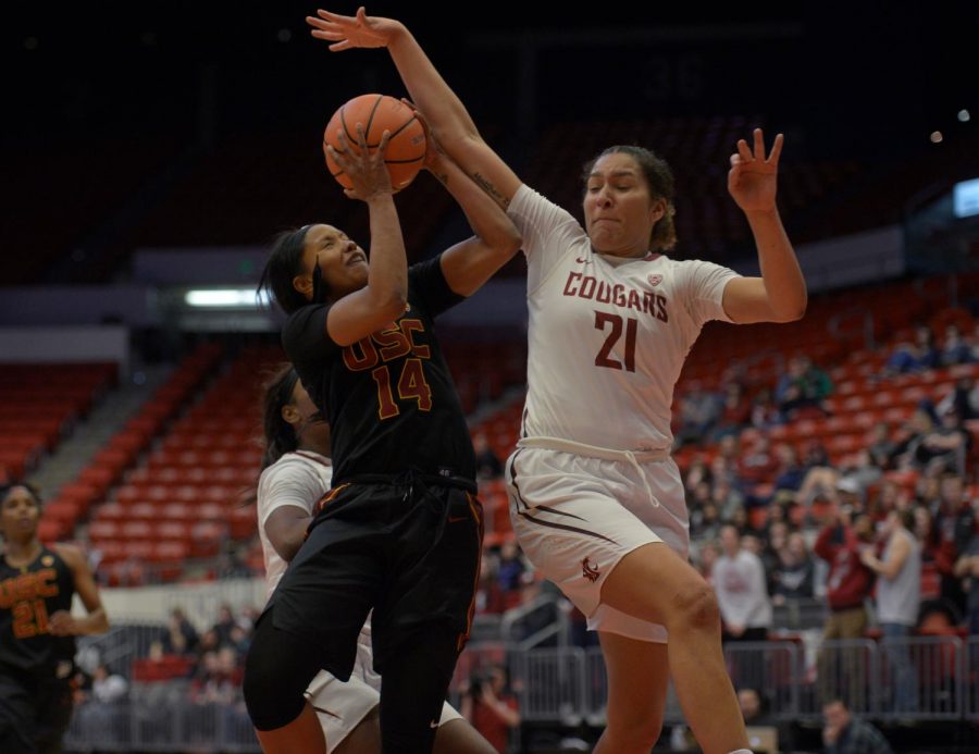 WSU redshirt junior forward Nike McClure goes up to block a shot from USC senior guard Sadie Edwards on Friday at Beasley Coliseum.