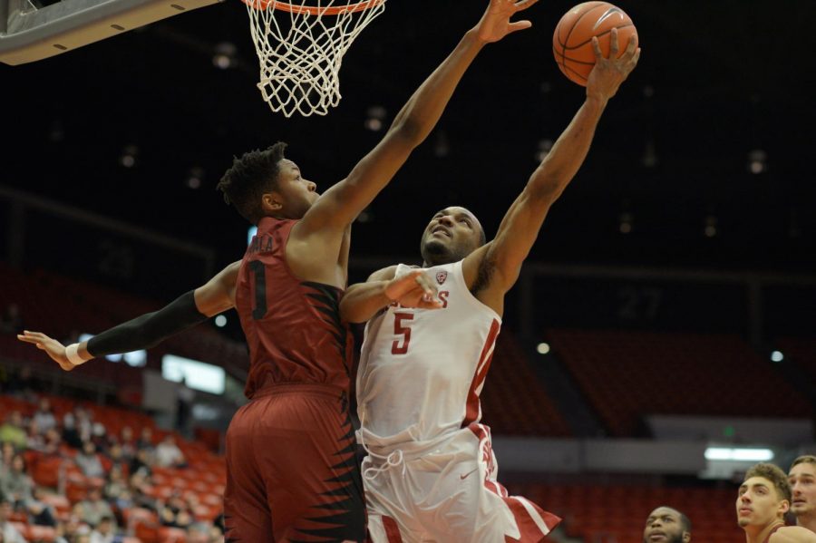 WSU redshirt freshman guard Milan Acquaah goes up for a layup over a Stanford defender on Jan. 11.