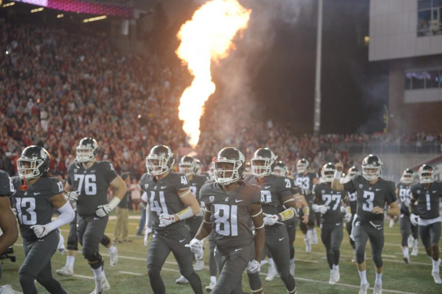 WSU football players run onto the field before the game against USC on Sept. 29 at Martin Stadium. WSU won 30-27.