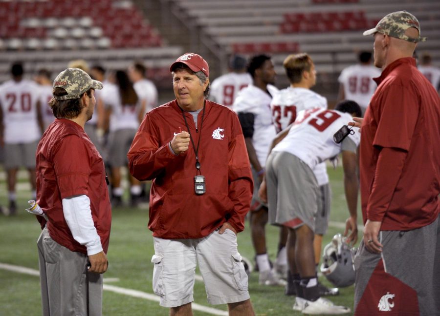 From left, then special teams coordinator Eric Mele, Head Coach Mike Leach and special teams quality control coach Tee Overman talk after practice on Aug. 20,2 017. 