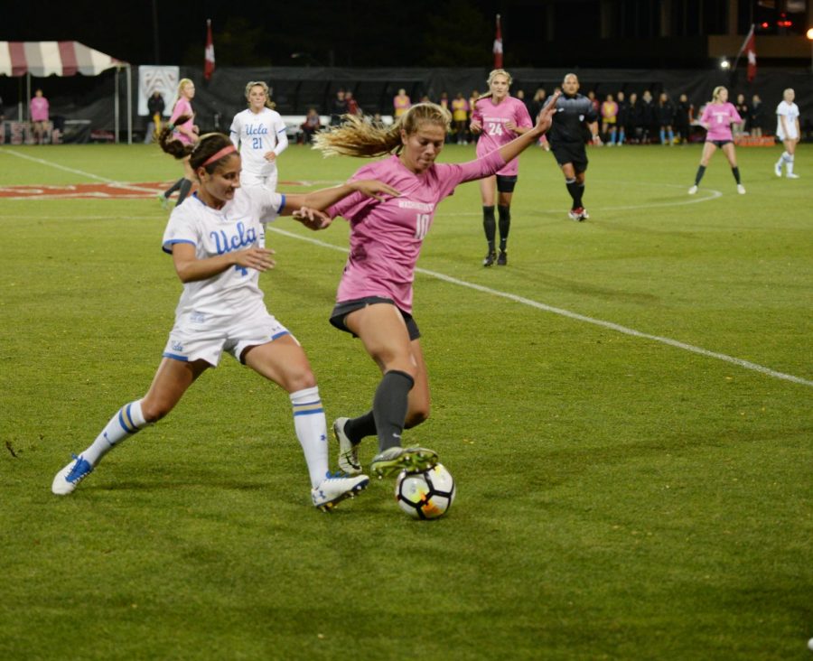 WSU freshman defender Aaqila Mclyn defends the ball from UCLA junior forward Hallie Mace on Oct. 19, 2017 at the Lower Soccer Field. WSU won the game 1-0.