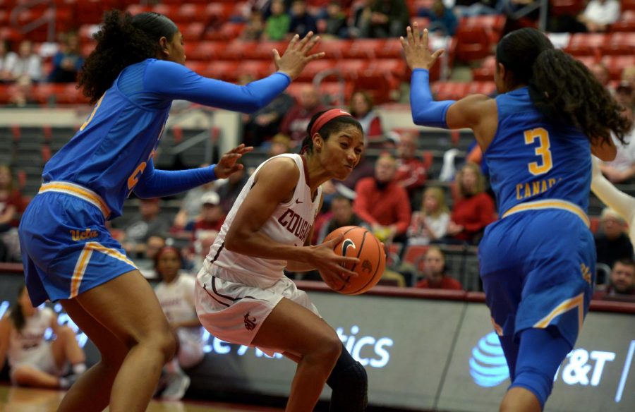 WSU+senior+guard+Caila+Hailey+fight+her+way+through+two+UCLA+defenders+in+a+game+on+Jan.+28+at+Beasley+Coliseum.