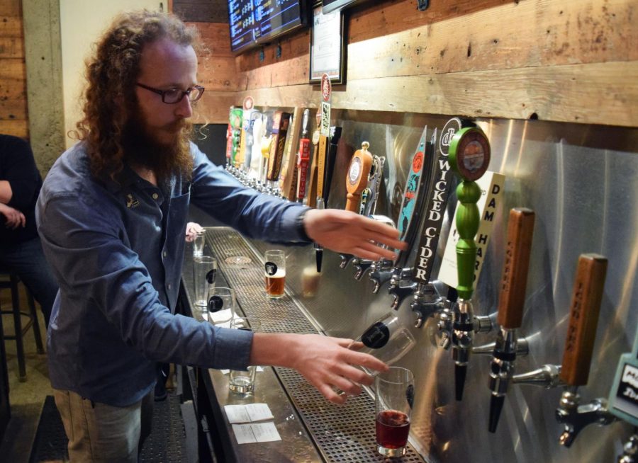 Ryan Hayes, a bartender at Tapped - Taphouse & Kitchen in Moscow, pours  a beer for a customer during Tuesday Triva night.