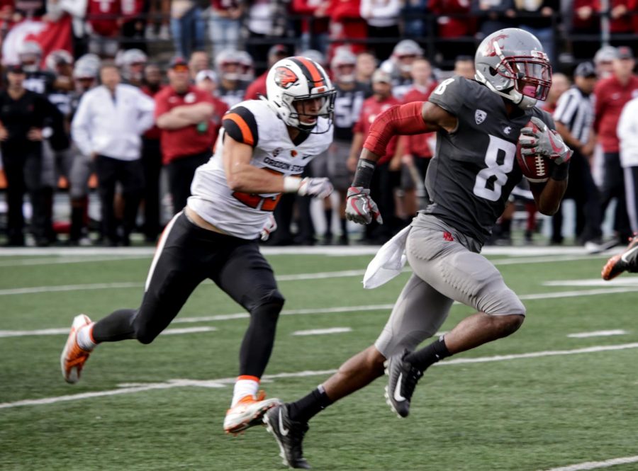 Wide receiver Tavares Martin Jr. runs down field to avoid Oregon State defenders on Sept. 16 at Martin Stadium.