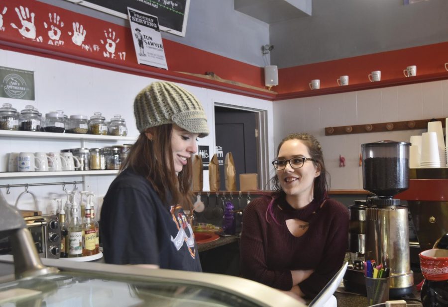 New co-owner CJ Robert, left, trains new barista Hailey Christy. Robert wants to display art from local community members, who she said supported her and her husband, Quincy, during the transition from Naughty Dog to Pups and Cups. 