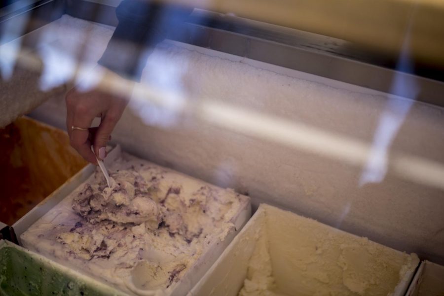 A worker takes a sample of huckleberry ice cream, Ferdinands Ice Cream Shoppes most popular flavor.