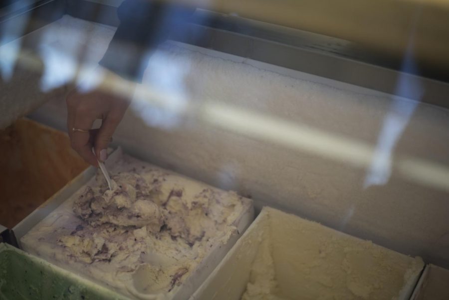 An employee scoops ice cream for a customer at Ferdinands Ice Cream Shoppe.