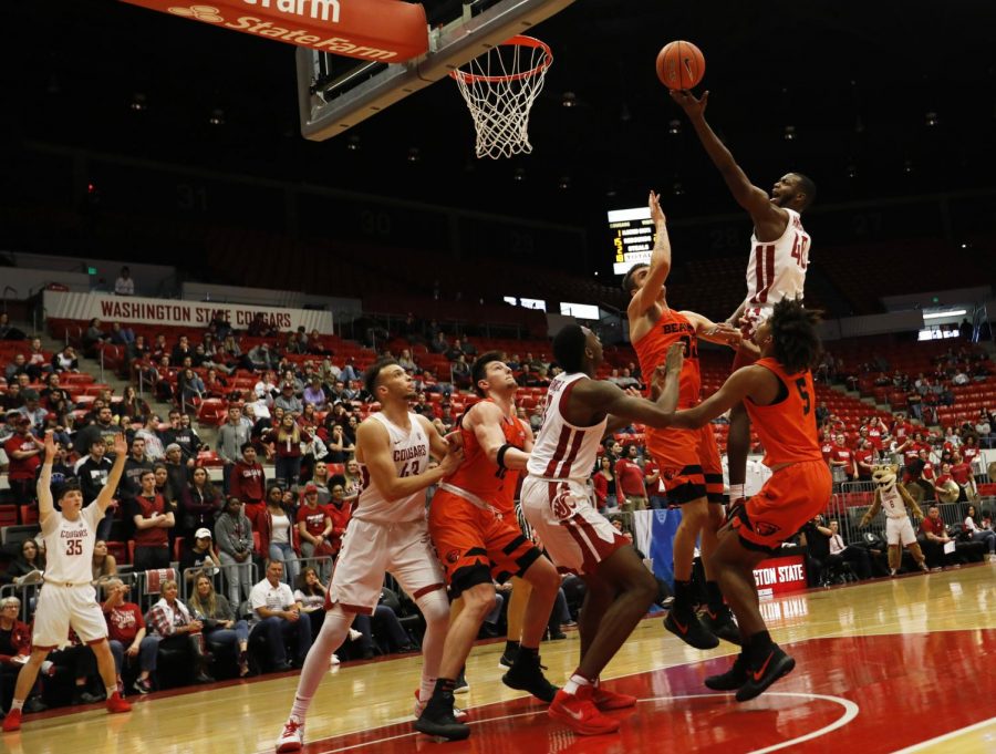 WSU junior guard Kwinton Hinson soars over Oregon State defenders and Cougar teammates as he goes for a layup Saturday night at Beasley Coliseum. Hinson scored five points in the game.