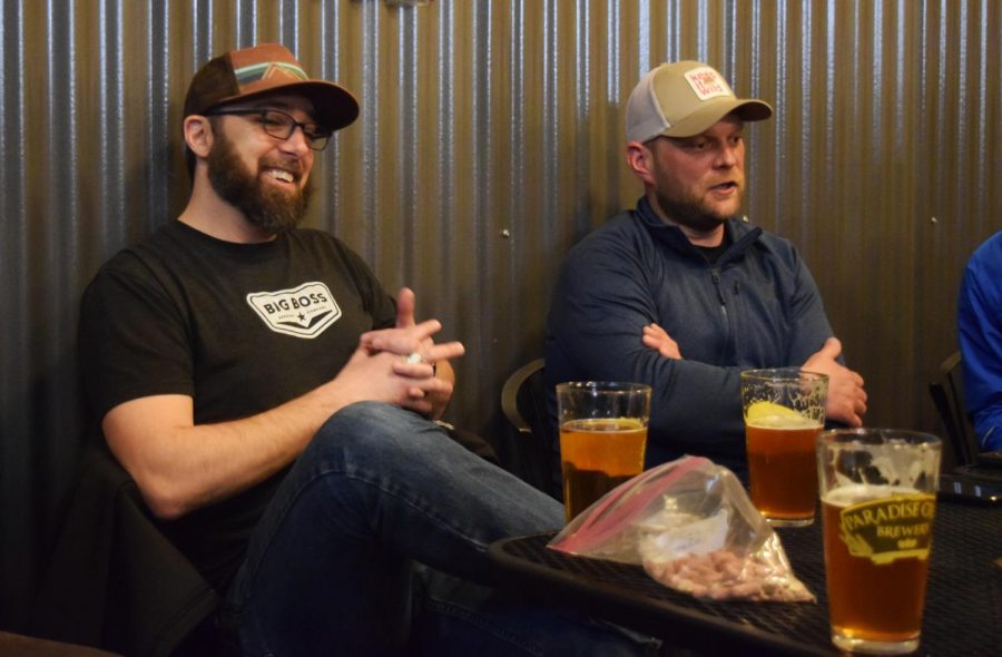 Jesse Clark, left, and Mark Tolman, founders of the Taproom Trail Runners, discuss how best to organize runs and whether dogs should be allowed. They took suggestions from other members at the club meeting.