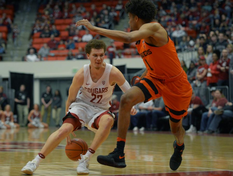 WSU sophomore guard Malachi Flynn navigates around Oregon State junior guard Stephen Thompson Jr. 
during a game on March 3 at Beasley Coliseum. WSU lost 92-67 to the Beavers in its final regular season game.