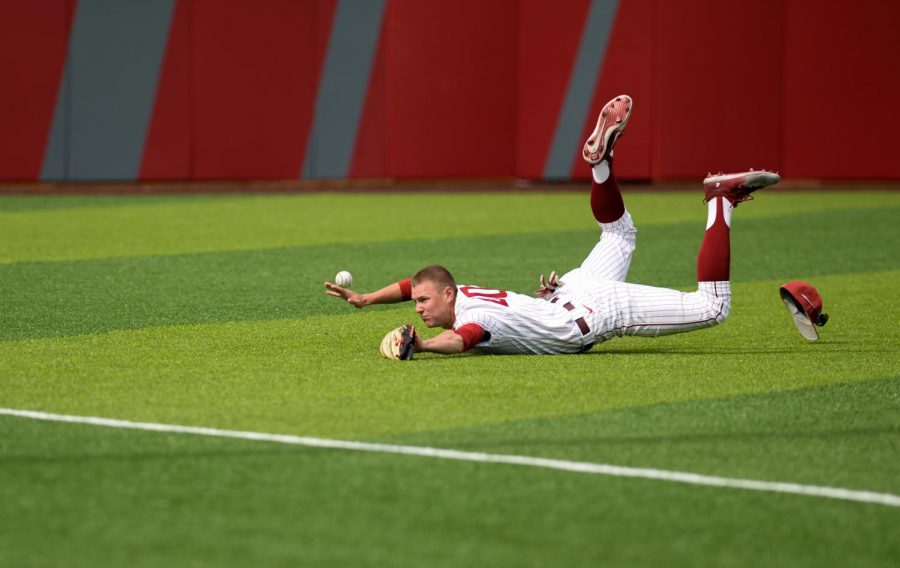 WSU sophomore outfielder Dustin Yates dives for the ball to get the out, but cannot come up with the catch against Arizona State University on March 31 at Bailey-Brayton Field.