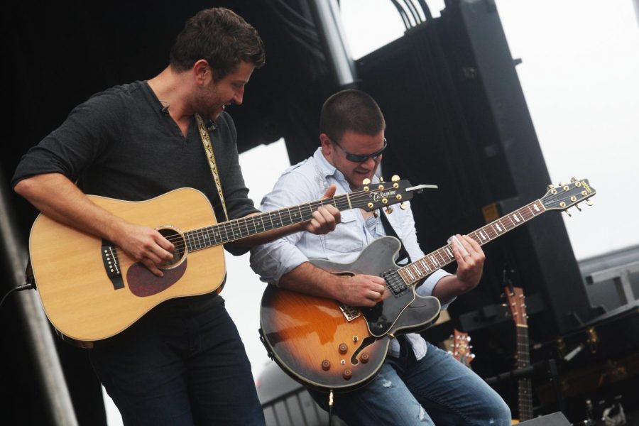 Country music singer, Brett Eldredge, left, and guitarist Charlie Hutto jam out during the North Carolina Country Music Freedom Festival, in Maysville, North Carolina. His new-school country voice has quickly made him popular.