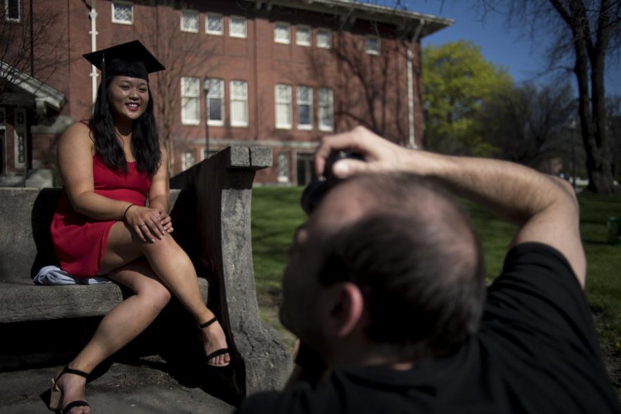 Guy Dutech, a graduate student, takes Elizabeth Les graduation photos, who is getting a degree in athletic training. Dutech is still learning how to take portraits but Le is just happy he could help her out.