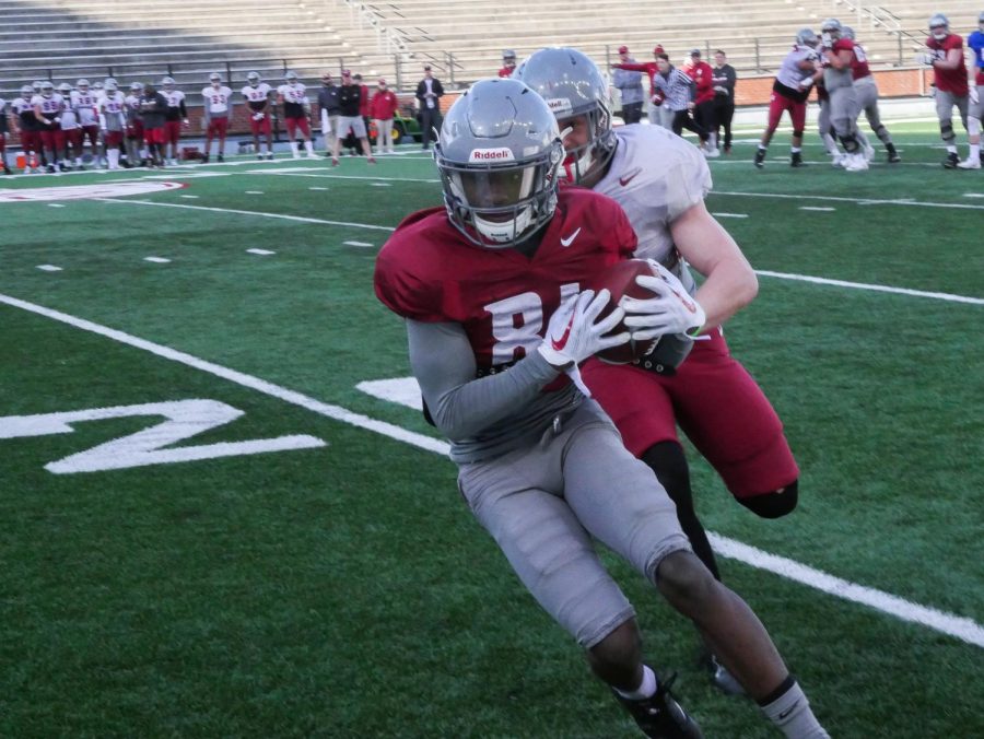 Redshirt sophomore wide receiver Renard Bell attempts to break away from redshirt sophomore linebacker Dillon Sherman during practice Saturday at Martin Stadium.