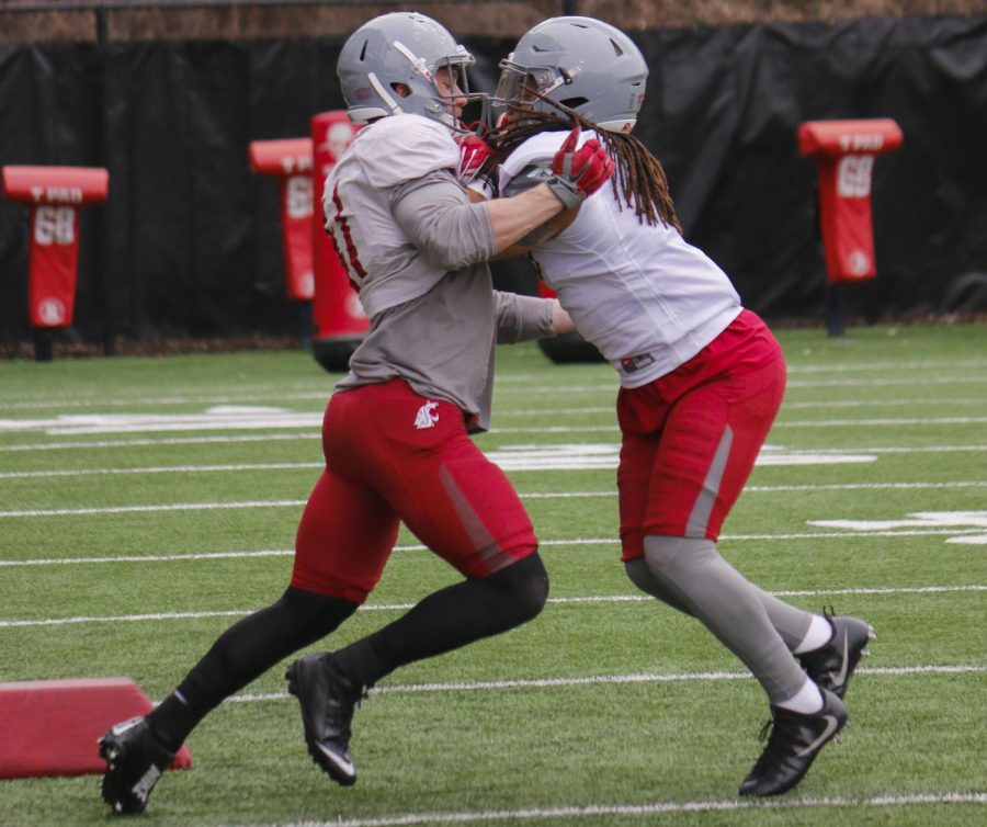 Redshirt sophomore linebackers Jahad Woods, left, and Dillon Sherman practice tackling techniques during spring practice April 3.