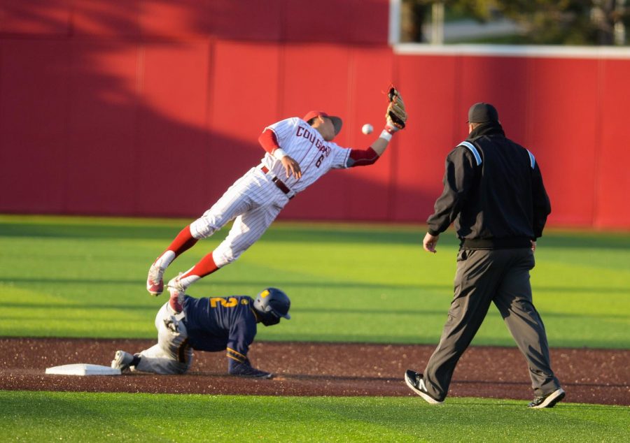 Freshman infielder Mason De La Cruz leaps over California Freshman infielder Darren Baker in an attempt to tag him out at second during a game against California at Bailey-Brayton Field