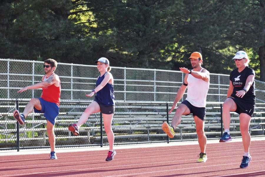 Palouse Road Runners members Ben Calabretta, left, Cara Hawkins-Jedlicka, Nicholas Potter and Carole Williams warm up prior to their weekly workout at the Dan O’Brien Track and Field Complex in Moscow. 