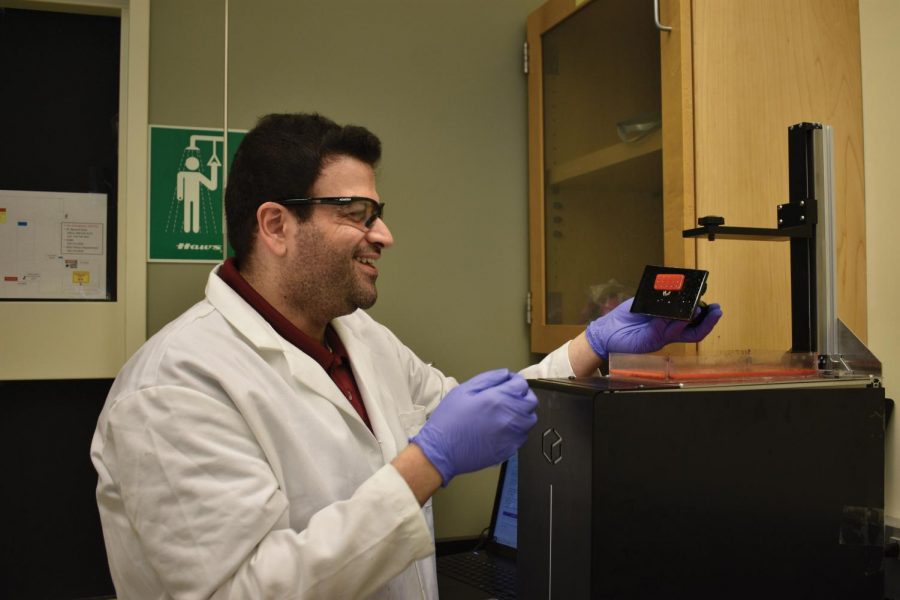 Doctoral student Maher Amer smiles as he finishes 3-D printing a mold for the hydrogel inside the Engineering Teaching and Research Lab building Tuesday. Amer said he was suprised this mold printed. “It’s a process,” he said. “We keep repeating it, but it actually printed.”