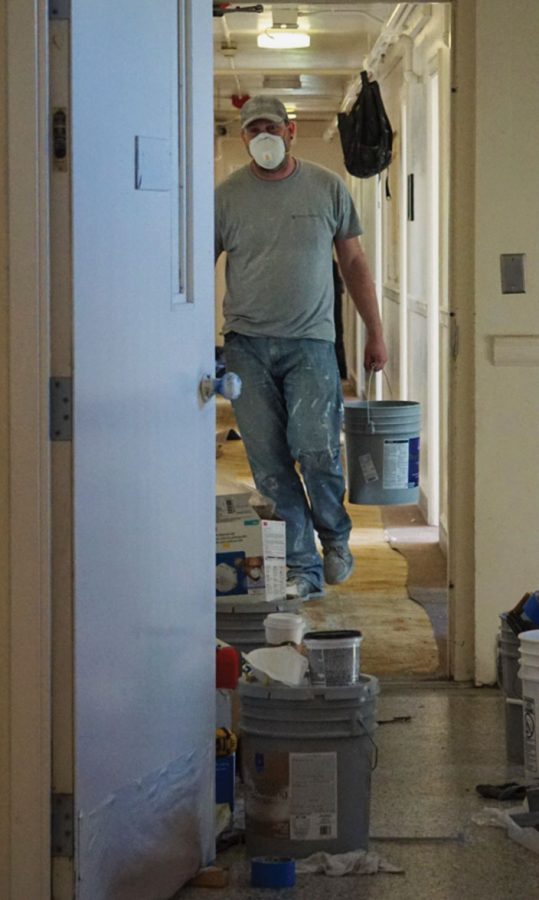Workers inside Waller Hall move to repair the interior of the dormitory Wednesday in preparation for a record freshman class.