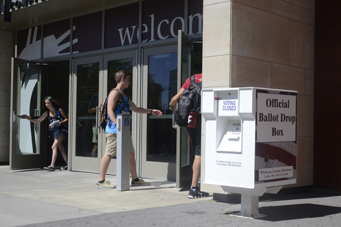 Students walk by the ballot drop box located outside of the CUB. 