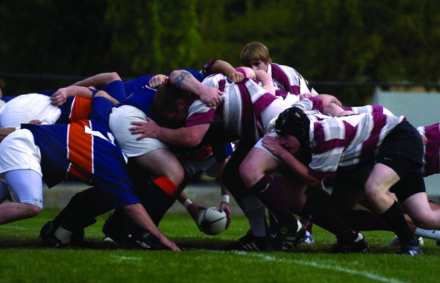 WSU men’s rugby club faces off against St. Andrews University in a scrum. Players often go with minimal or without head protection.