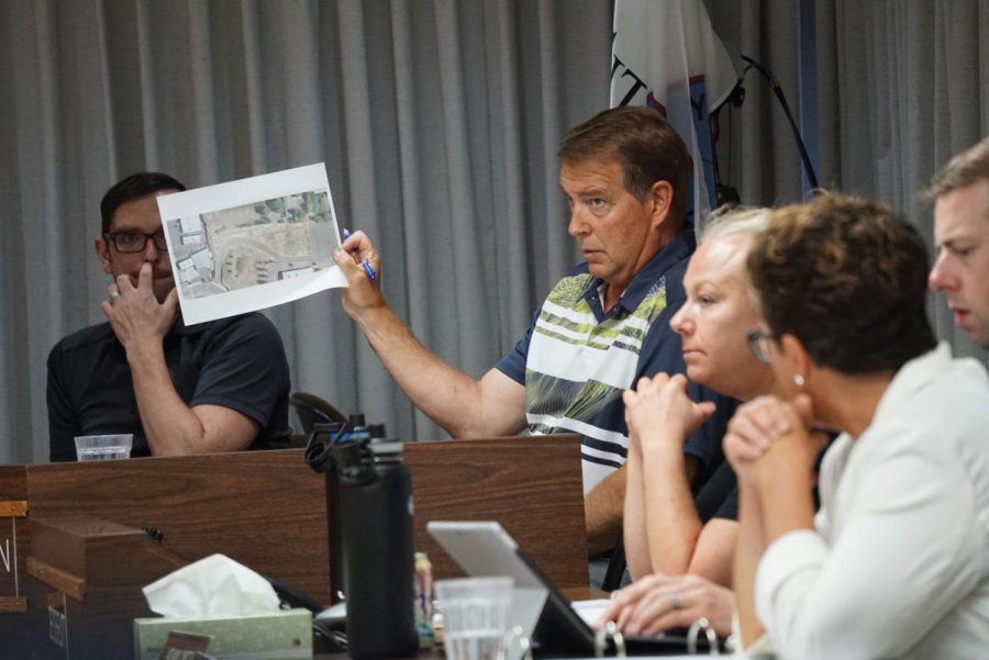 Councilmember Al Sorensen holds up a map showing possible solar panel construction at the new City Hall building during a City Council meeting Tuesday night.