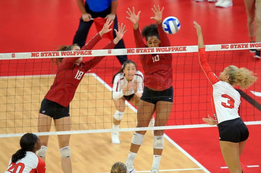 Senior+middle+blocker+Ella+Lajos%2C+left%2C+and+senior+outside+hitter+Taylor+Mims%2C+middle%2C+jump+to+block+a+hit+made+by+North+Carolina+sophomore+opposite+Melissa+Evans+on+Aug.+26+in+Reynolds+Coliseum.