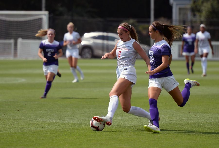 Junior forward Morgan Weaver attempts to keep the ball away from GCU junior defender Fiona Samodurov during the match against GCU on Aug. 19 at the Lower Soccer Field.