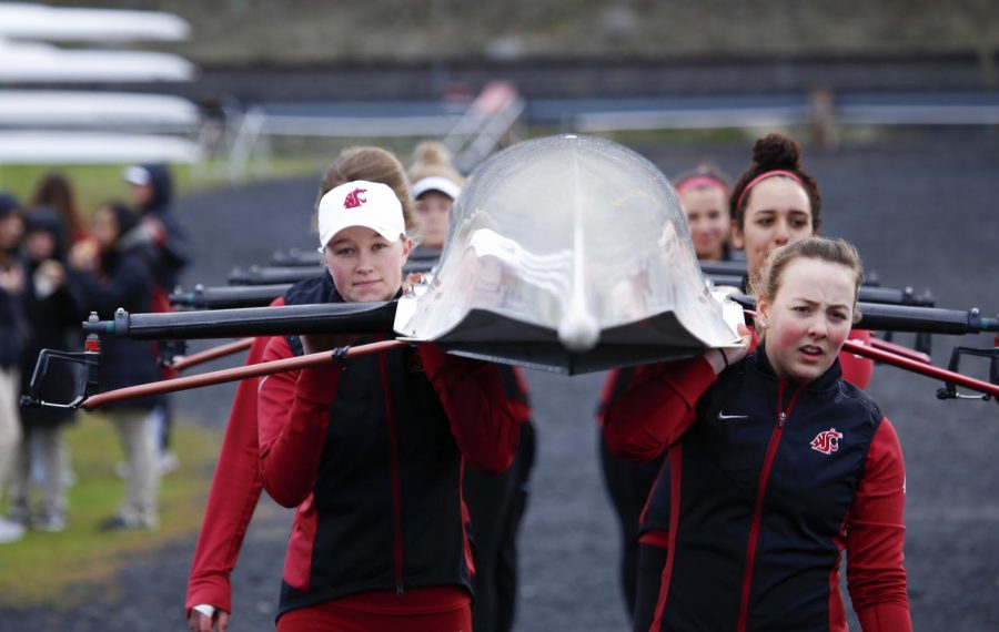 Members of the 2016-17 WSU rowing team carry their shell to the Wawawai Landing on the Snake River on Mar. 25, 2017 at the Fawley Cup.