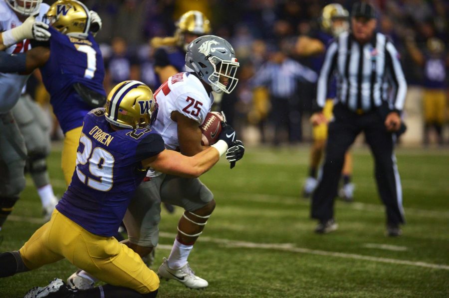 Then-redshirt senior running back Jamal Morrow breaks through UW’s then-senior outside linebacker Connor O’Brien tackle during the 2017 Apple Cup on Nov. 25 in Husky Stadium.