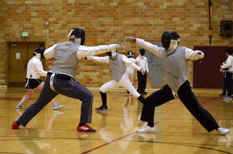 Fencing club member and coach Zach Mellin, left, fences Matthew Rosefield on Thursday night in Smith Gym.