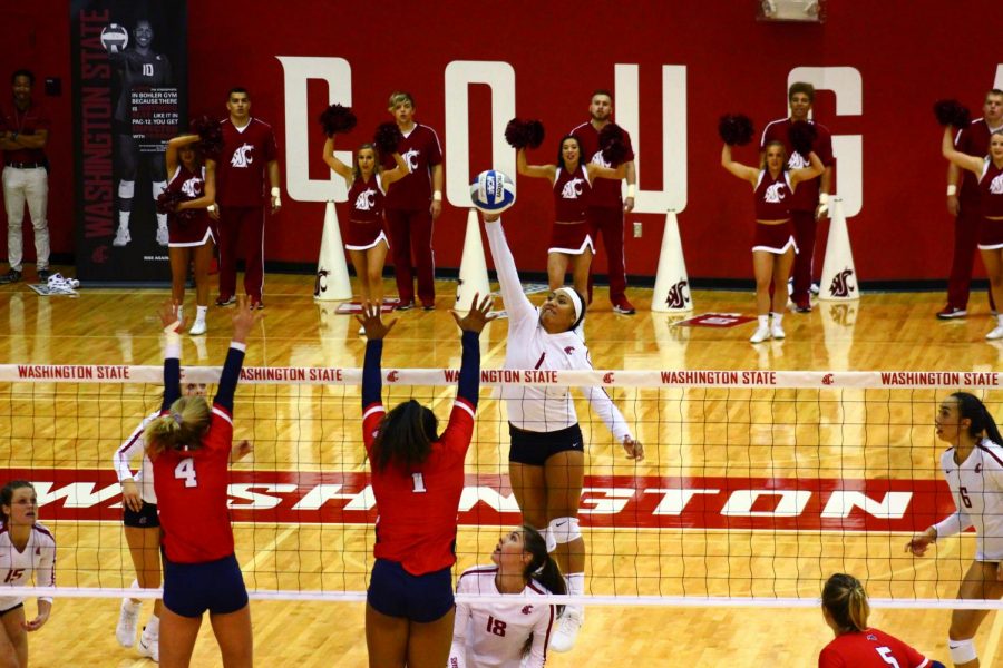 Sophomore outside hitter and setter Penny Tusa spikes over a pair of Stony Brook blockers Friday in Bohler Gym.