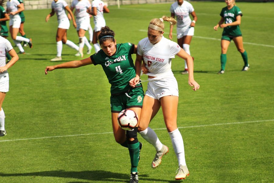 Junior forward Morgan Weaver battles for the ball against Cal Poly freshman defender Emily Talmi at the game Sunday at the Lower Soccer Field.