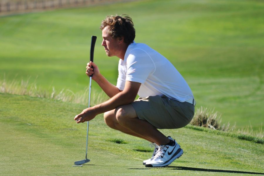 Then-junior Blake Snyder contemplates his putt during WSU men’s golf practice on Sept. 19 2013 at Palouse Ridge Golf Club.