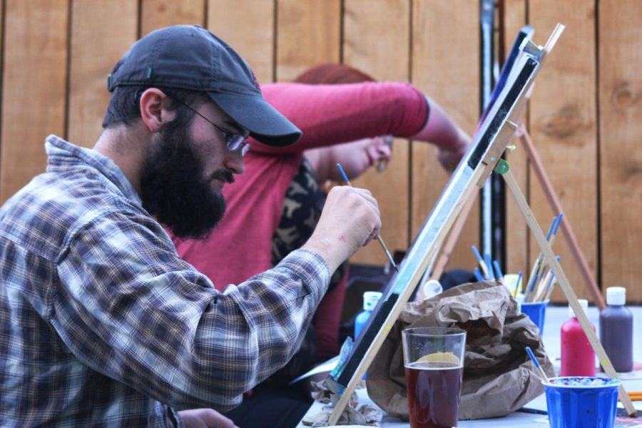 Brushes+and+Brews+attendee+Mark+Bennett+adds+details+to+his+canvas+at+Paradise+Creek+Brewerys+Trailside+Taproom+on+Tuesday+night.+