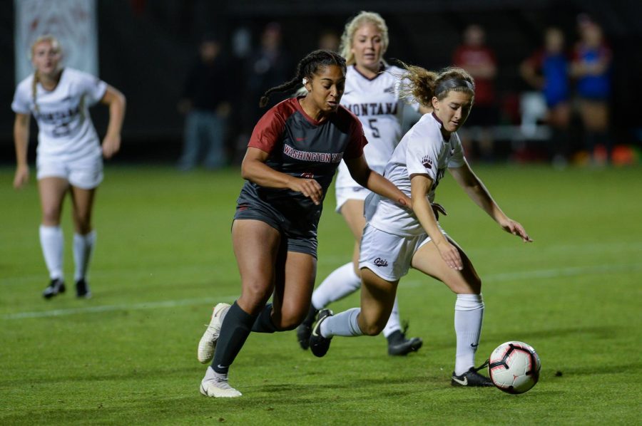 Freshman midfielder Ebony Clarke fights for the ball in the second half of the game against Montana on Friday night at the Lower Soccer Field.