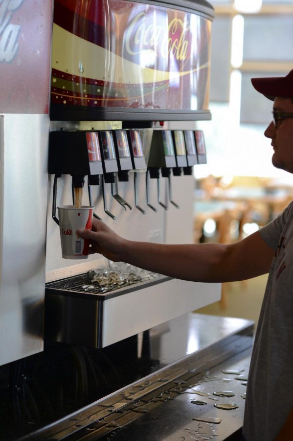 Michael Wheeler, a freshman engineering major, pours himself a cup of soda Wednesday in Southside Cafe. After seltzer water comes to dining halls, students should choose health over taste.