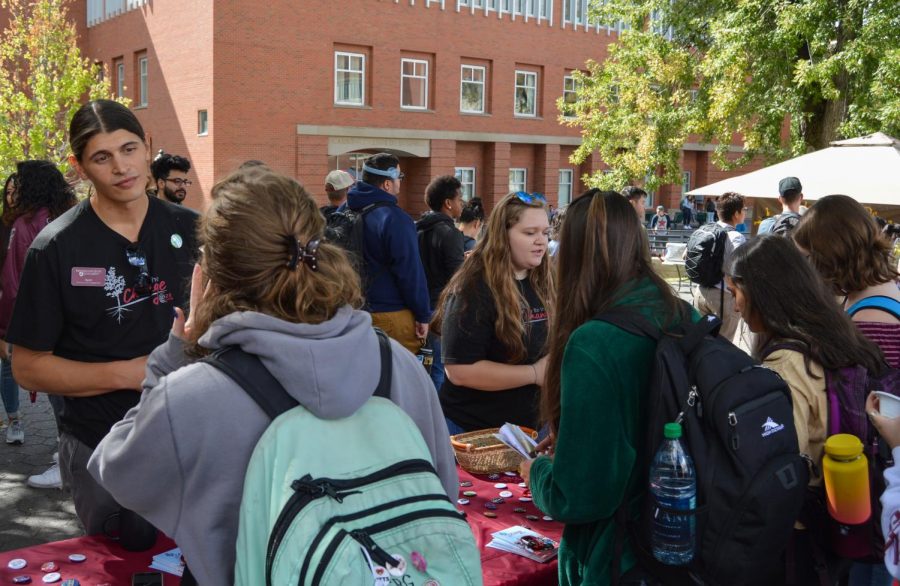 Ryan Lazo, left, community partnership coordinator for the Center for Civic Engagement, and graduate assistant Marie Gray speak with students about activities and events for Civic Engagement during Connect Fest on Wednesday afternoon on Glenn Terrell Mall.