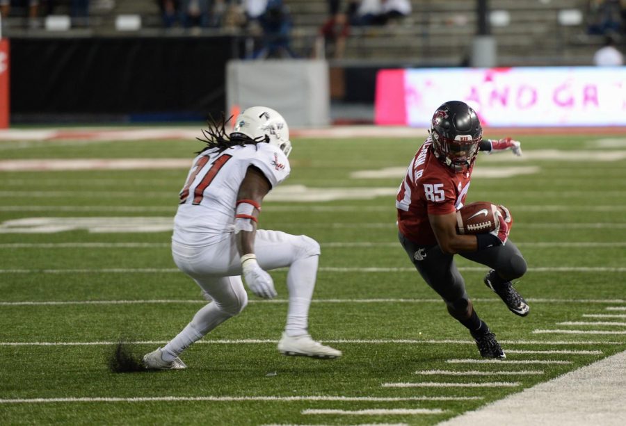 Junior wide receiver Calvin Jackson Jr. turns away from an Eastern Washington player while rushing down the sideline in the game against Eastern Washington on Sept. 20 at Martin Stadium.