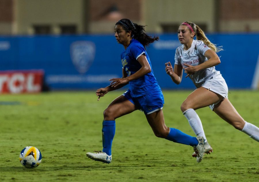 Junior forward Morgan Weaver, right, attempts to take possession of the ball from UCLA sophomore midfielder Viviana Villacorta in the game against the Bruins Friday night at Wallis Annenberg Stadium.